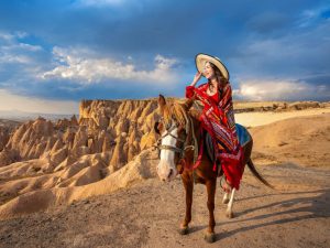 tourists enjoy ride horses cappadocia turkey