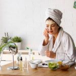 Woman having skin care at home